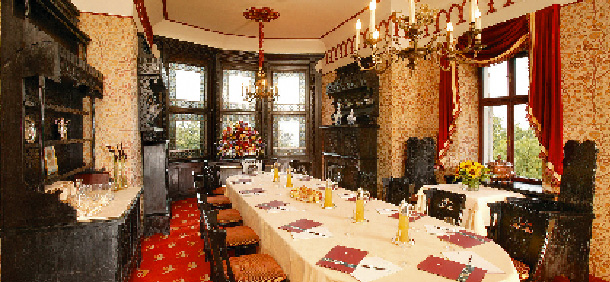 eine lange tafel schön gedeckt mit einem prunkvollen kronleuchter 