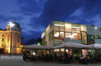 Ein Schanigarten auf dem Hauptplatz bei Nacht ist zu sehen 
