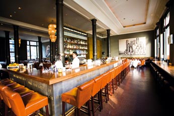 eine viereckige Bar mit braunen lederstühlen 