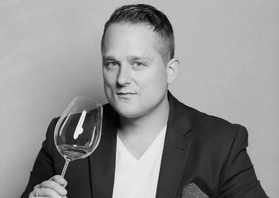 Porträt von Sommelier Andre Macionga mit Weinglas